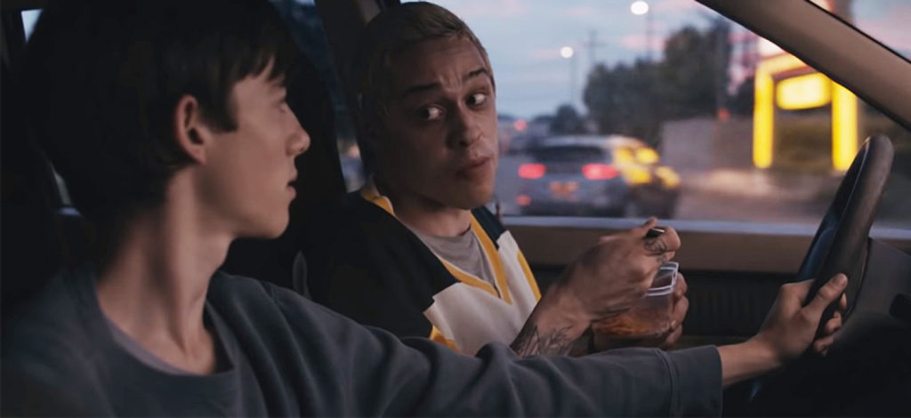 Pete Davidson and Griffin Gluck talking in a car in the film Big Time Adolescence